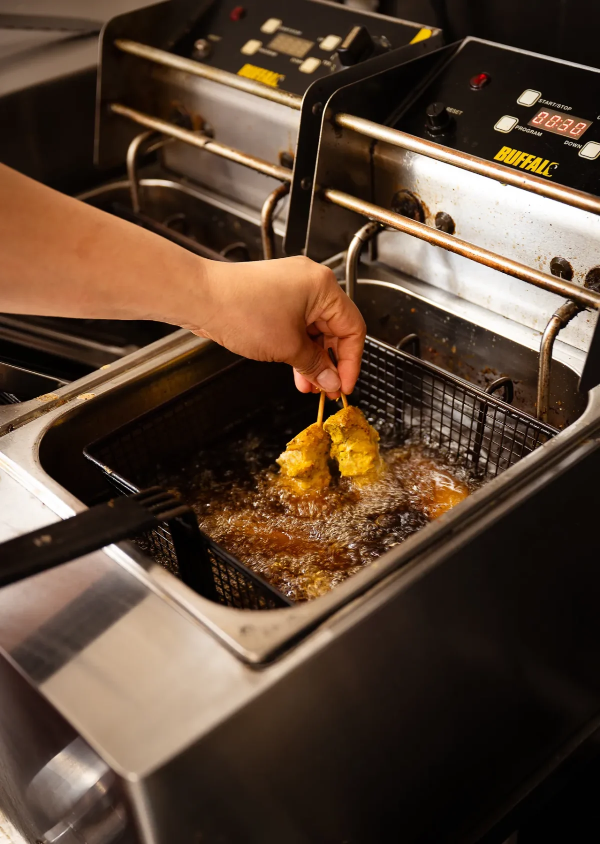A chef frying at high heat in the kitchen