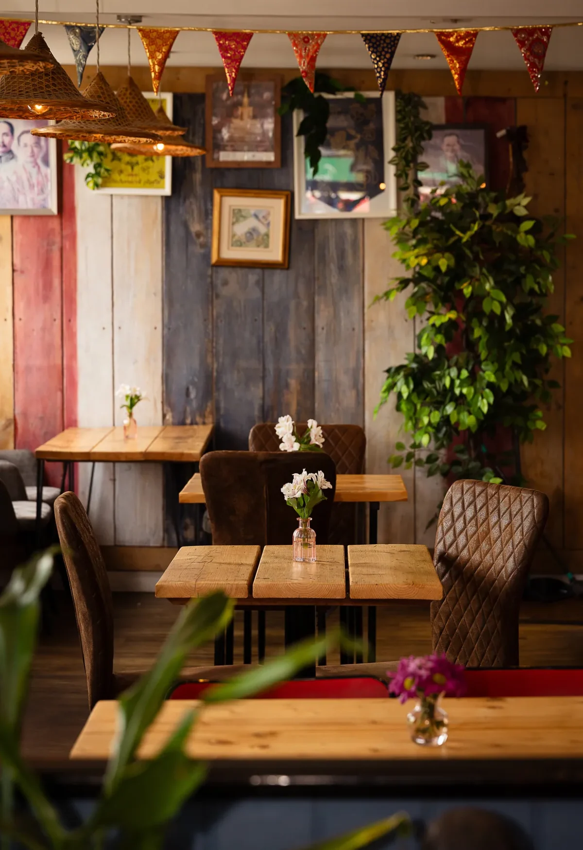 The Wadebridge dining room with timber walls and Thai bunting