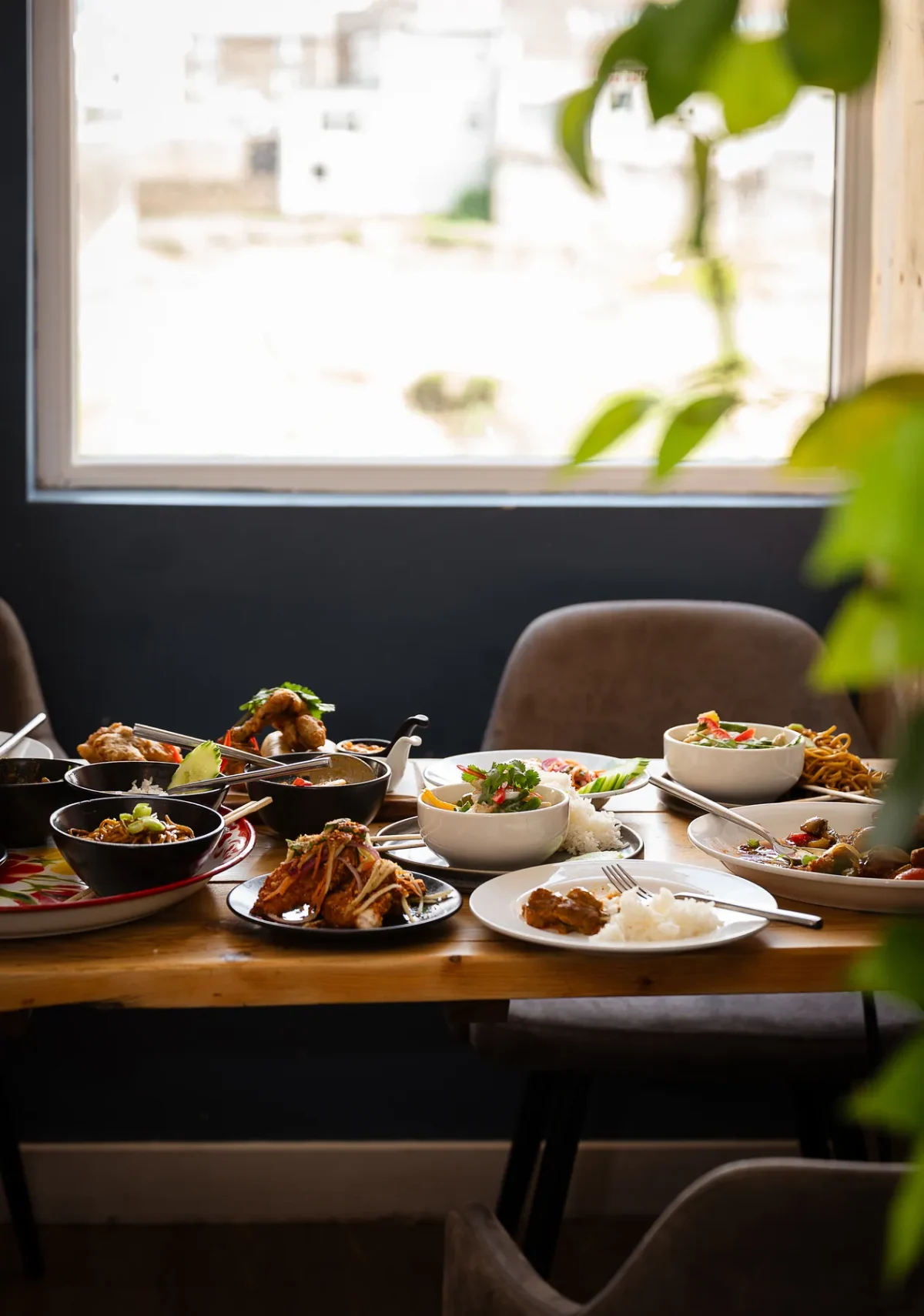 A table laid beside the window at The Tiny Thai in Wadebridge, looking out to the light