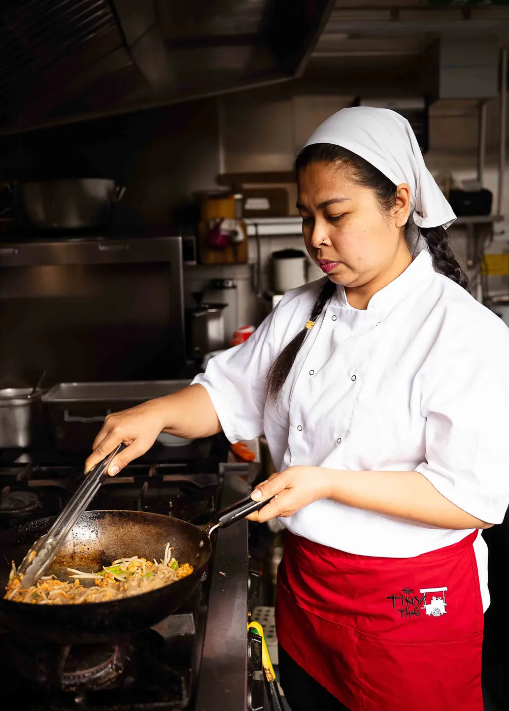 A chef cooking at the wok in the Newquay kitchen